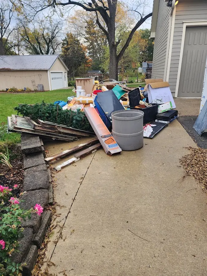 Dumpster being loaded with debris for Estate Cleanout Dumpster Rental in Blanchard